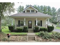 Charming home with a welcoming porch swing and nicely landscaped front yard at 489 Highland St, Morgantown, IN 46160