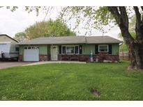 Charming ranch-style home with an inviting green lawn and brick accents at 5041 Norcroft Dr, Indianapolis, IN 46221