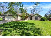 Charming brick home with a lush green lawn and an attached two-car garage at 601 Shady Ln, Greenwood, IN 46142