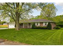 Charming brick ranch-style home with manicured lawn and attached garage at 9303 Leroy Rd, Brownsburg, IN 46112