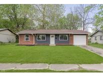 Charming single-story home with a brick and siding exterior and well-maintained lawn at 10132 E 33Rd St, Indianapolis, IN 46235