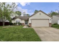 Charming single-story home with a two-car garage, well-maintained lawn, and lovely landscaping at 10688 Ashview Dr, Fishers, IN 46038