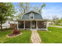 Charming home featuring a welcoming screened-in porch and a beautifully landscaped front yard with a stone walkway at 116 High St, Brooklyn, IN 46111