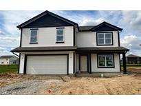 Charming two-story home with a two-car garage, white siding and contrasting black trim at 1216 Mcbride St, Greenfield, IN 46140