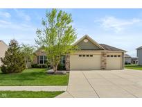 Beautiful single-story home featuring a three-car garage, stone accents, and a well-manicured lawn at 131 Stamford Dr, Pittsboro, IN 46167