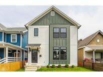 Charming two-story home with white siding, green trim, and well-manicured lawn at 1534 Fletcher Ave, Indianapolis, IN 46203