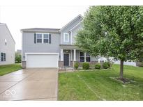 Charming two-story home with an attached garage and well-maintained lawn at 2006 Creek Bank Dr, Columbus, IN 47201