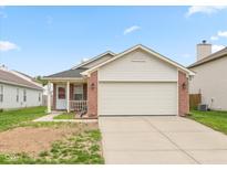 Charming single Gathering home with a brick facade, attached two-car garage and manicured lawn at 2623 Santaro Ct, Indianapolis, IN 46217