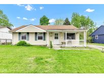 Charming home featuring a cozy front porch and well-maintained lawn at 2625 N Boehning St, Indianapolis, IN 46219
