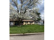 Charming single-story home with lush green lawn, flowering tree, and well-manicured landscaping at 5218 Fletcher St, Anderson, IN 46013