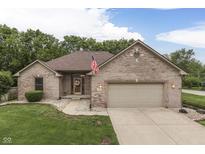 Charming brick home featuring an attached garage, well-manicured lawn, and a welcoming front entrance at 5499 Steven Dr, Greenwood, IN 46142