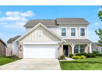 Charming two-story home featuring a two-car garage, a manicured lawn, and a welcoming front entrance at 5518 Wood Spring Ln, McCordsville, IN 46055