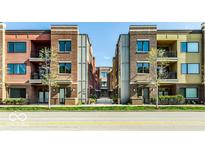 Contemporary condo building with brick facade and black iron balconies offering a modern urban living experience at 622 E 10Th St # 212, Indianapolis, IN 46202