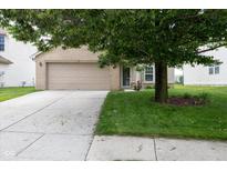 Charming home featuring a two-car garage, brick accents, and a well-maintained lawn at 6516 Amherst Way, Zionsville, IN 46077