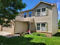 Charming two-story home featuring a well-manicured lawn, attached garage, and delightful curb appeal at 6516 Amherst Way, Zionsville, IN 46077