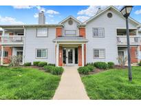 Inviting condominium exterior showcasing manicured lawn and a welcoming entrance at 8120 Glenwillow Ln # 206, Indianapolis, IN 46278