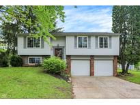 Two-story home featuring a front-facing two-car garage and well-maintained landscaping at 831 Wakulla Ct, Indianapolis, IN 46217