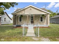 Charming stone-clad home featuring a cozy front porch with wood supports and manicured lawn at 997 Yandes St, Franklin, IN 46131