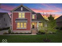 Charming two-story home featuring a well-manicured lawn and tasteful landscaping at 1013 Domino Dr, Carmel, IN 46032