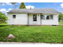 Charming single-story home with white siding, a covered porch, and a well-maintained green lawn at 1020 E Sixth St, Greenfield, IN 46140