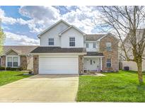 Charming two-story home featuring a two-car garage, a mix of vinyl siding and brick, and a well-maintained lawn at 11419 Pegasus Dr, Noblesville, IN 46060
