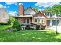 Charming two-story brick home with a manicured lawn and inviting front porch at 11620 E 75Th St, Indianapolis, IN 46236