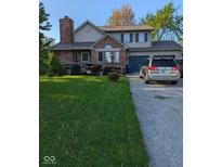 Charming two-story home with brick facade, attached garage, and well-maintained front yard at 11620 E 75Th St, Indianapolis, IN 46236
