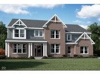 Stunning two-story home with brick and siding, a welcoming front porch, and beautiful architectural details at 11841 Sage Creek Bnd, Fishers, IN 46037