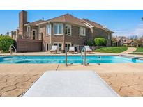 Inviting backyard pool with lounge chairs, decking, and view of the home's brick exterior at 2015 Saint Andrews Ct, Franklin, IN 46131