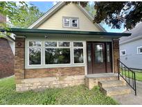 Charming bungalow featuring a brick foundation, and inviting front entrance at 2119 S Garfield Dr, Indianapolis, IN 46203