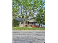 Charming single-story home with a brick porch and mature trees adding character to the property at 3547 N Emerson Ave, Indianapolis, IN 46218