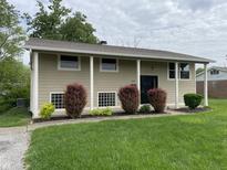 Charming two-story home with landscaped front yard, and inviting entryway with large columns at 3720 E Southern Ave, Indianapolis, IN 46203