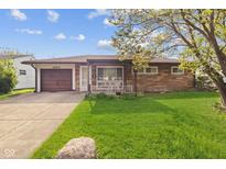 Charming single-story home featuring a stone facade, attached garage, and well-maintained lawn at 4864 N Katherine Dr, Indianapolis, IN 46226