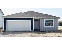 New construction shows a charming single story home with a two-car garage and complementary two-tone paint at 5204 Cartland Dr, Indianapolis, IN 46239