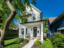 Charming two-story home with a beautifully landscaped front yard and inviting front porch at 544 N Beville Ave, Indianapolis, IN 46201