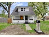Charming renovated home with a vibrant yellow front door and freshly painted white exterior at 555 S Auburn St, Indianapolis, IN 46241