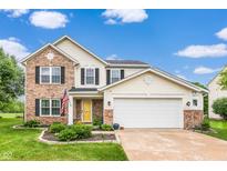 Charming two-story home with a brick and vinyl exterior, attached two-car garage, and landscaped front yard at 5617 Gainesway Dr, Greenwood, IN 46142