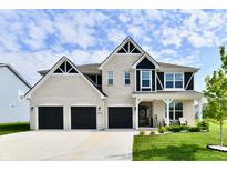 Beautiful white brick home with a three-car garage, well-maintained lawn, and welcoming front porch at 6398 Marden Trl, Brownsburg, IN 46112