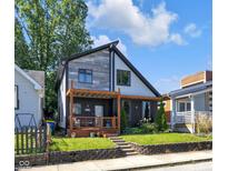 Contemporary two-story home featuring a welcoming front porch and nicely landscaped yard at 715 Terrace Ave, Indianapolis, IN 46203
