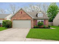 Charming single-story brick home featuring an attached two-car garage and well-maintained landscaping at 11108 Oakridge Dr, Fishers, IN 46038