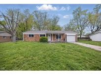 Charming brick ranch home with a one car garage and a well maintained lawn and landscaping at 1116 Heatherwood Dr, Indianapolis, IN 46241