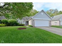 Charming single-story home with a well-manicured lawn and attached two car garage at 11541 Coastal Dr, Indianapolis, IN 46229
