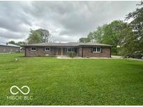 A charming single-story brick home features a well-maintained lawn and classic design elements at 1171 S Daisy Ln, New Palestine, IN 46163