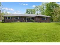 A single-story brick home with a well-manicured lawn and traditional architectural details at 1171 S Daisy Ln, New Palestine, IN 46163