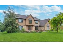 Charming two-story home with a combination of stone and siding exterior and well-maintained landscaping at 1421 Stoney Creek Cir, Carmel, IN 46032