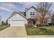 Charming two-story home with attached garage and manicured front yard at 14584 Hinton Dr, Fishers, IN 46037