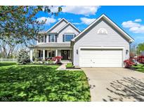 Charming two-story home with a manicured lawn, inviting porch, and two car garage, creating a welcoming curb appeal at 14817 Deerwood Dr, Carmel, IN 46033