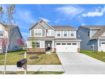 Charming two-story home featuring a two-car garage, well-manicured lawn, and welcoming entrance at 17344 Hanningfield Way, Westfield, IN 46074