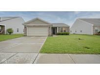 Charming single-story home features a brick facade, well-maintained lawn, and an attached two-car garage at 1739 Elderberry Dr, Indianapolis, IN 46234