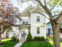 Charming two-story home with manicured lawn and inviting front porch, perfect for relaxing at 2251 N New Jersey St, Indianapolis, IN 46205